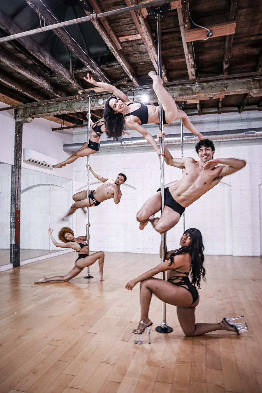 IncrediPole members training together on the poles in the Gowanus loft