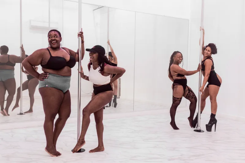 Four IncrediPole students standing together in the studio between rounds