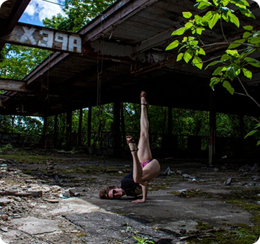 An outdoor pole handstand shoot in an abandoned building